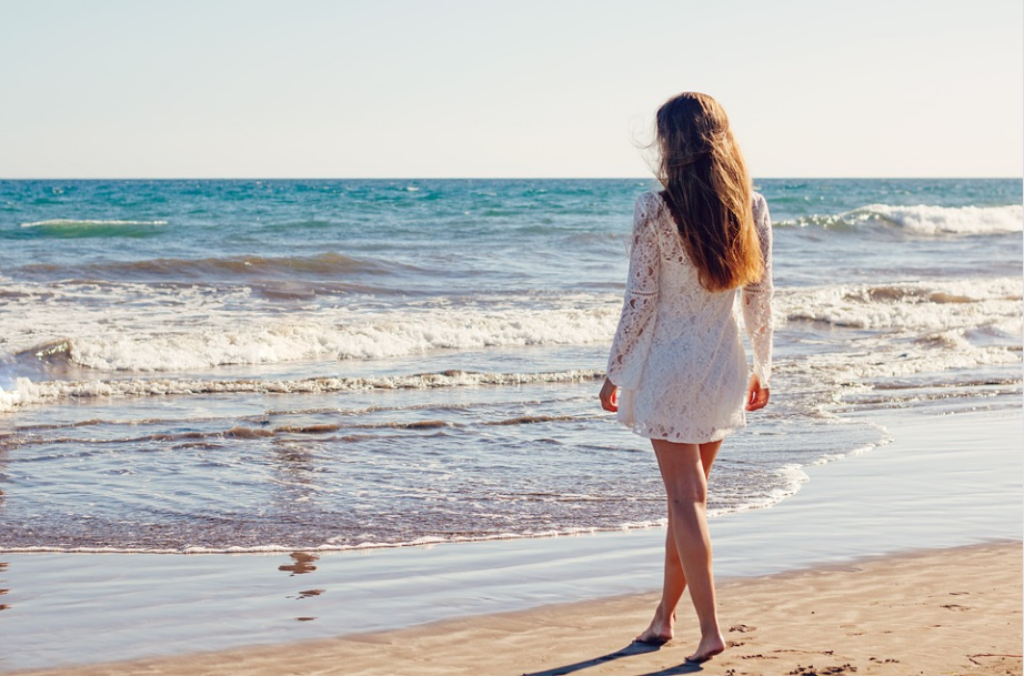 a woman standing on the beach