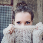 a woman covering half of her face