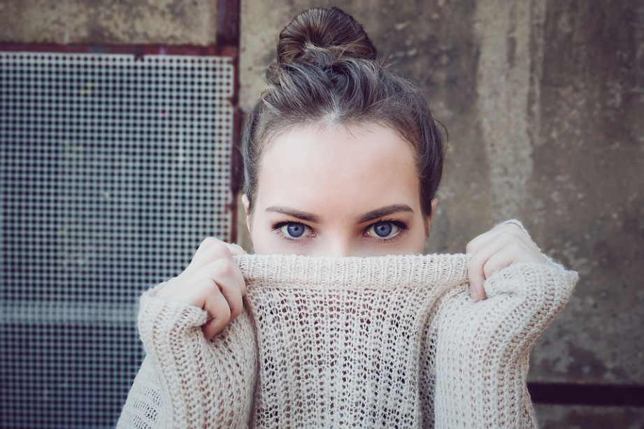 a woman covering half of her face